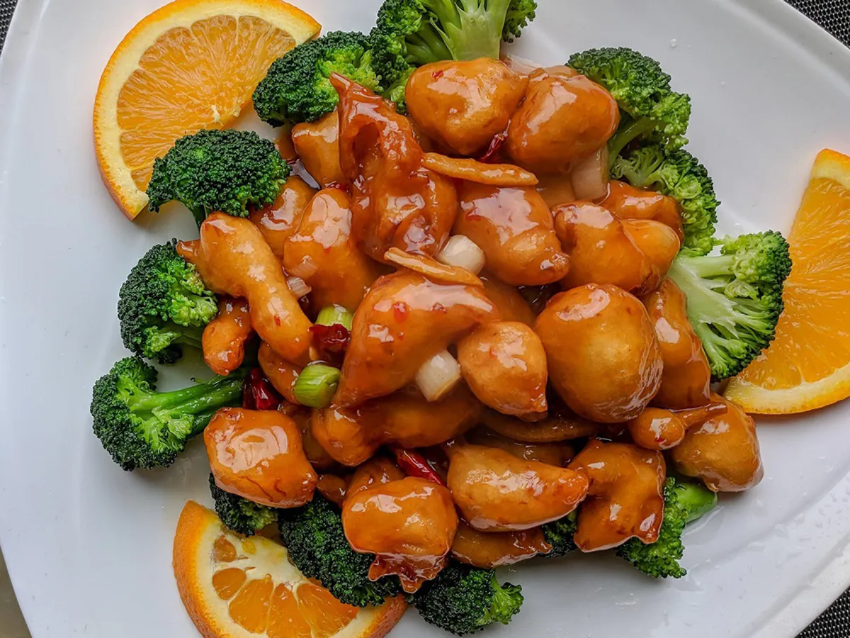 Sweet orange glazed chicken with fresh broccoli and orange slices at YUKI Sushi & Wok, an Asian Fusion Restaurant in Wayne